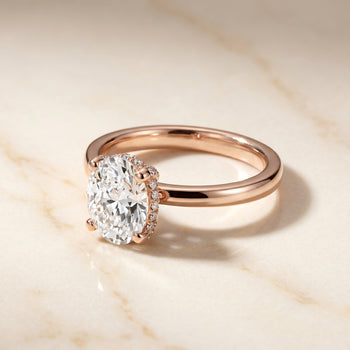 The Lana Secret Halo Adorned Prong Solitaire Oval Engagement Ring Setting in 14K Rose Gold