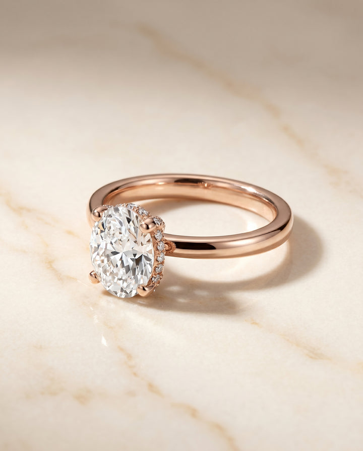 The Lana Secret Halo Adorned Prong Solitaire Oval Engagement Ring Setting in 14K Rose Gold