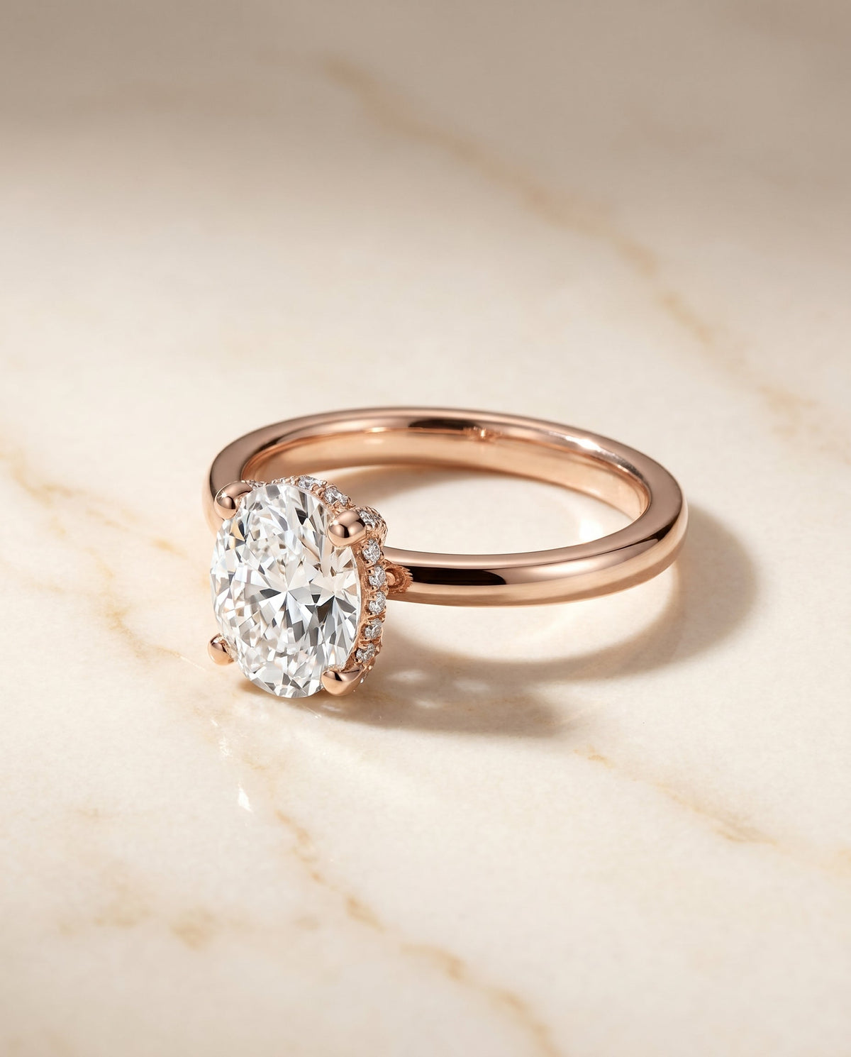 Lana Select Hidden Halo Oval Lab Diamond Engagement Ring in 14K Rose Gold, shown on hand, angled | RockHer