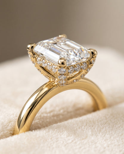 The Lana Secret Halo Adorned Prong Solitaire Emerald Cut Engagement Ring Setting in 18K Yellow Gold
