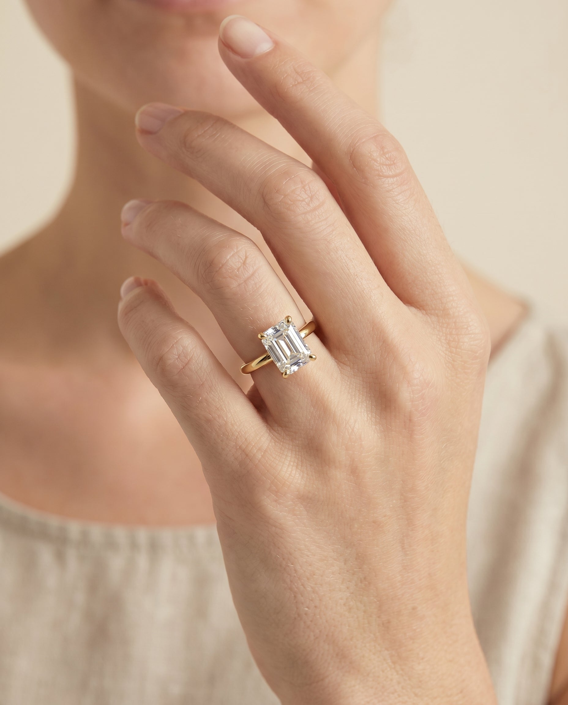 The Lana engagement ring setting in 18K Yellow Gold, secret halo adorned prong solitaire cut design | RockHer