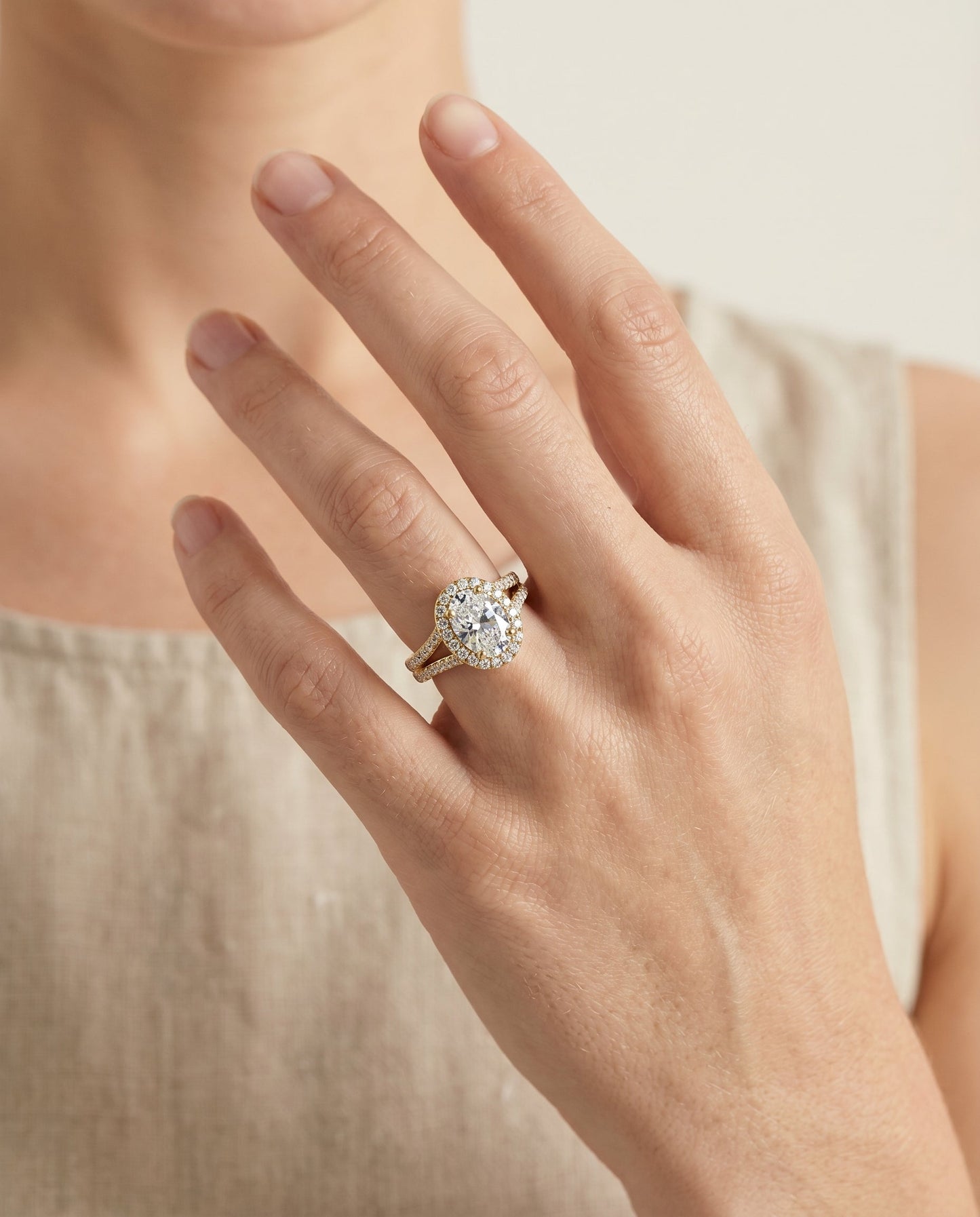 Lira Select Halo Oval Lab Diamond Engagement Ring in 18K Yellow Gold, shown on hand | RockHer
