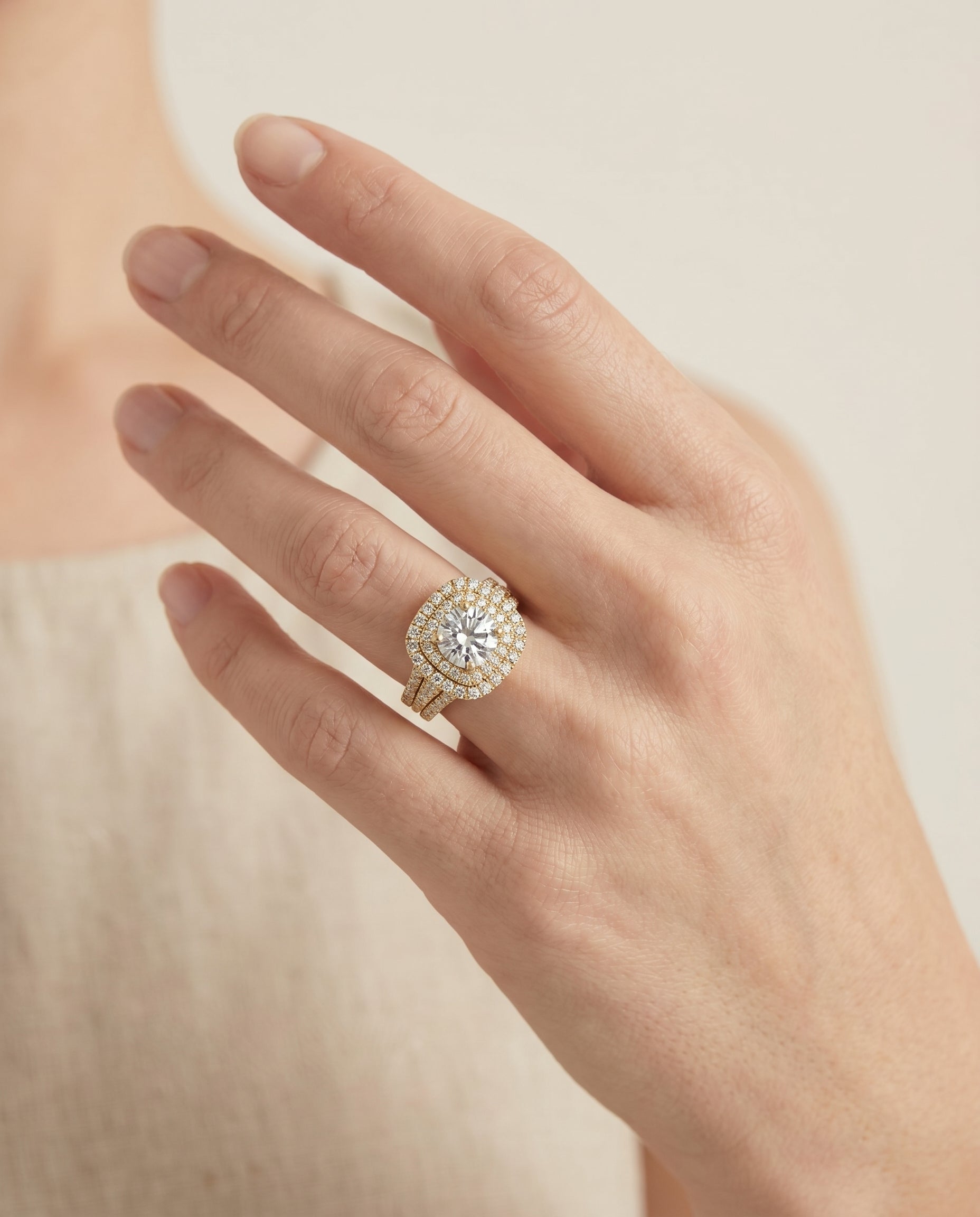 Lyra Select Double Halo Round Lab Diamond Engagement Ring in 18K Yellow Gold, shown on hand, angled | RockHer