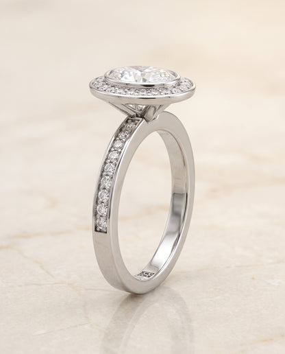 The Marcia Bezel Halo Channel Band Oval Engagement Ring Setting in 18K White Gold