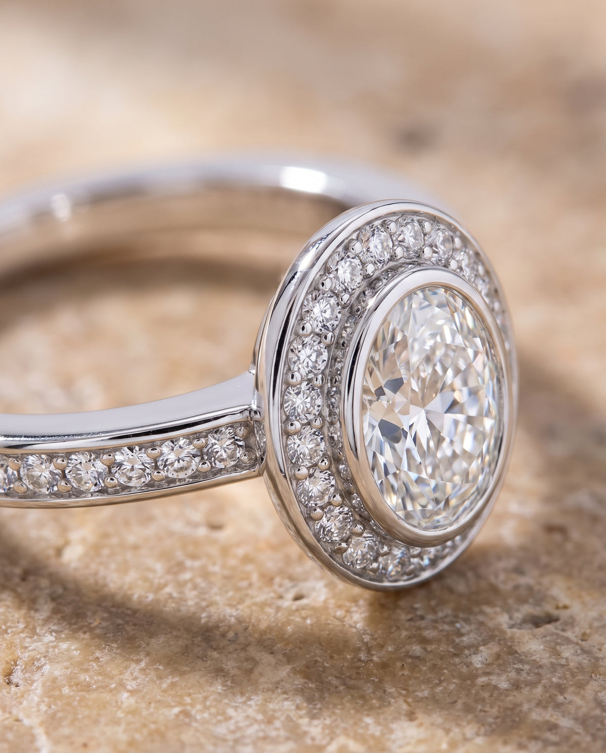 The Marcia Bezel Halo Channel Band Oval Engagement Ring Setting in 18K White Gold