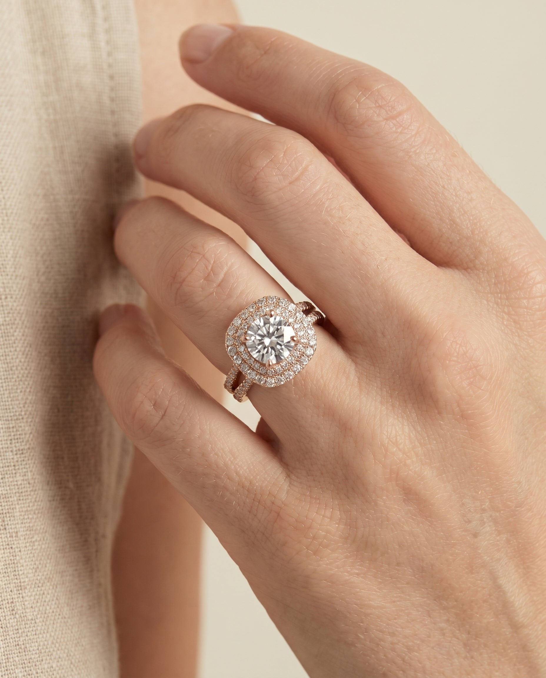 Maria Select Linear Double Row Halo Round Lab Diamond Engagement Ring in 14K Rose Gold, shown on hand, angled | RockHer