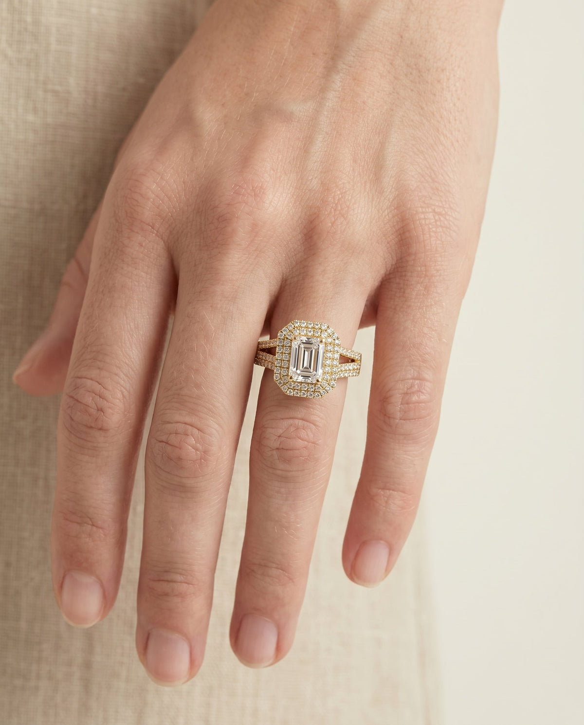 Mariah Select Halo Emerald Cut Lab Diamond Engagement Ring in 18K Yellow Gold, shown on hand | RockHer