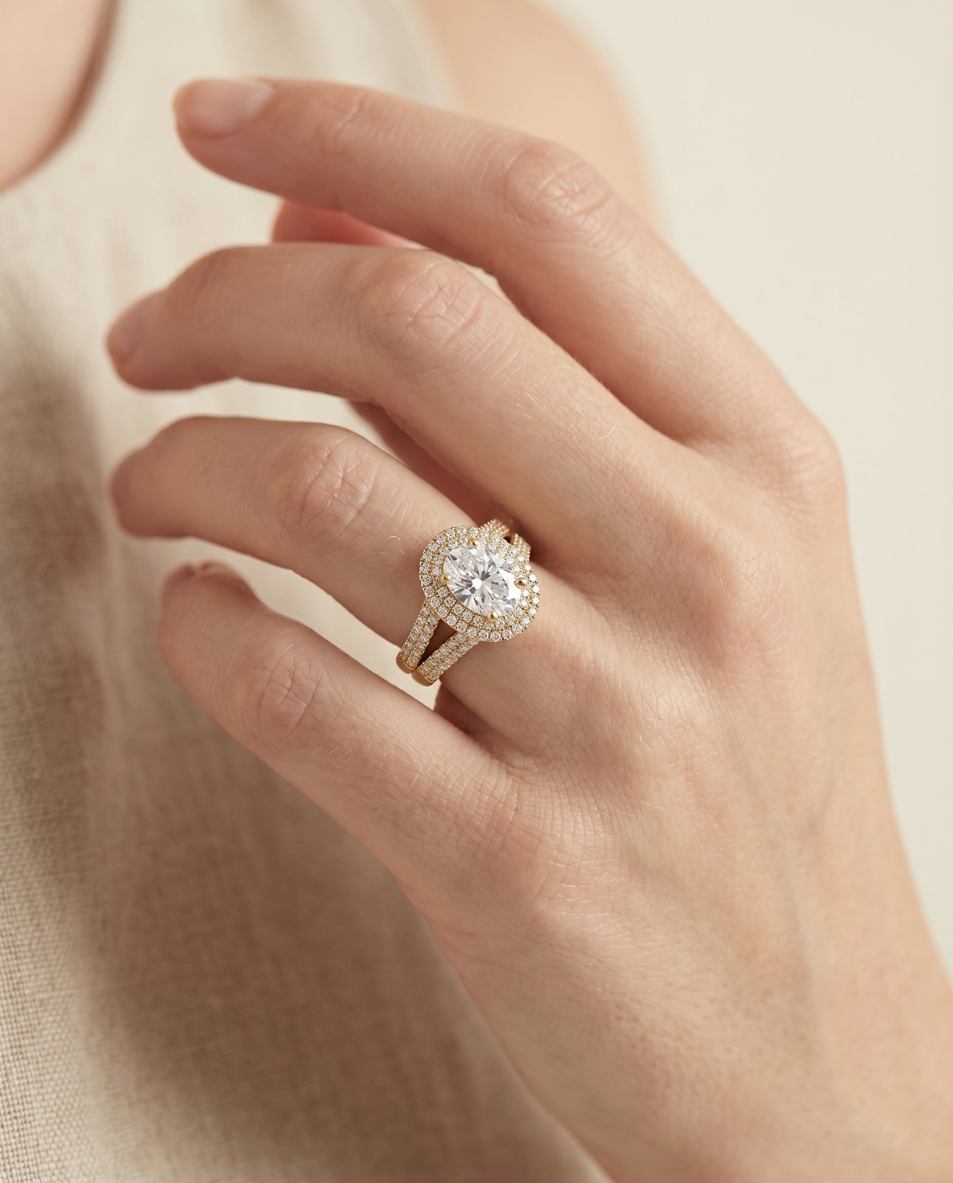 Mariah Select Three Tier Halo Crown Oval Lab Diamond Engagement Ring in 18K Yellow Gold, shown on hand, angled | RockHer