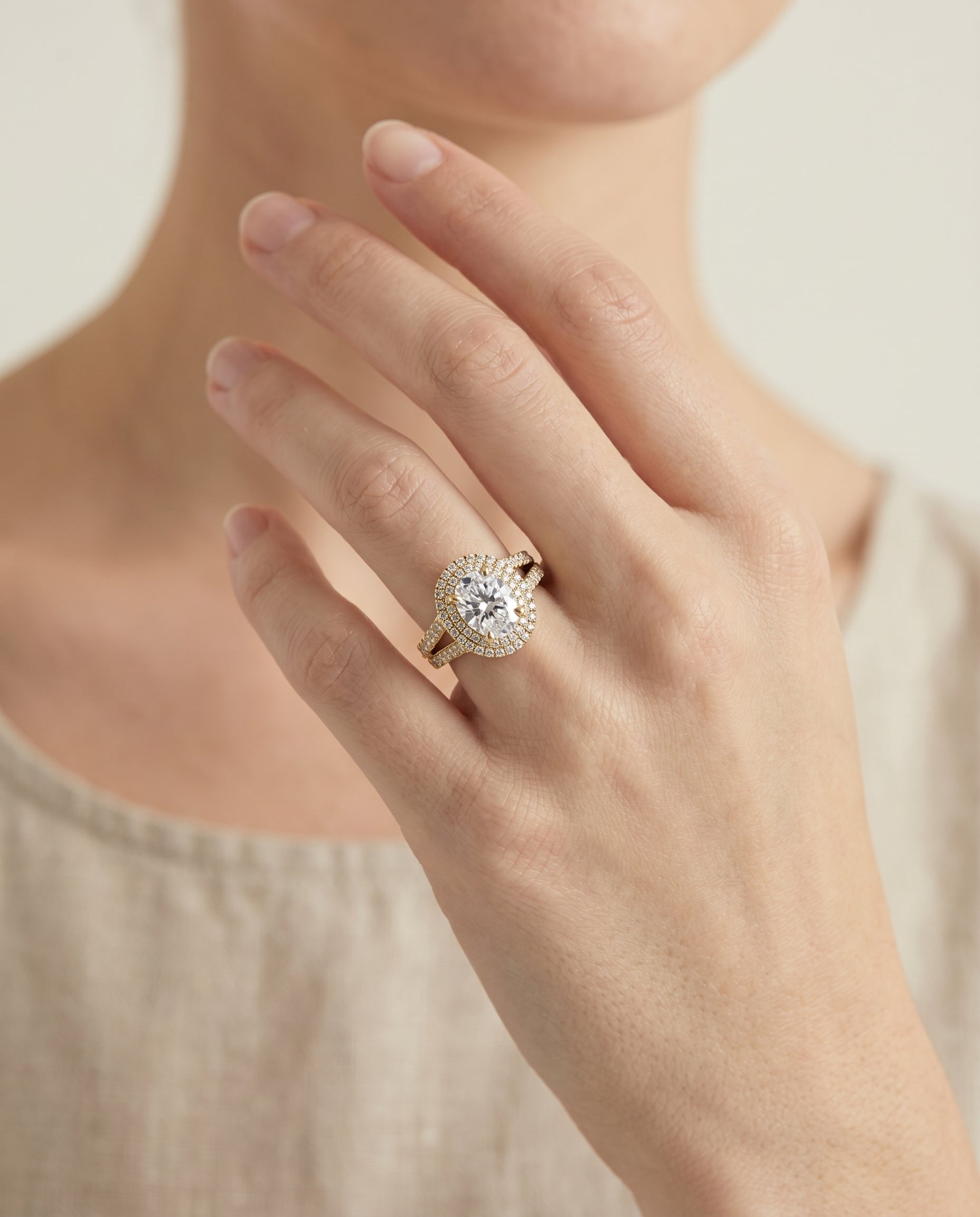 Mariah Select Three Tier Halo Crown Oval Lab Diamond Engagement Ring in 18K Yellow Gold, shown on hand | RockHer