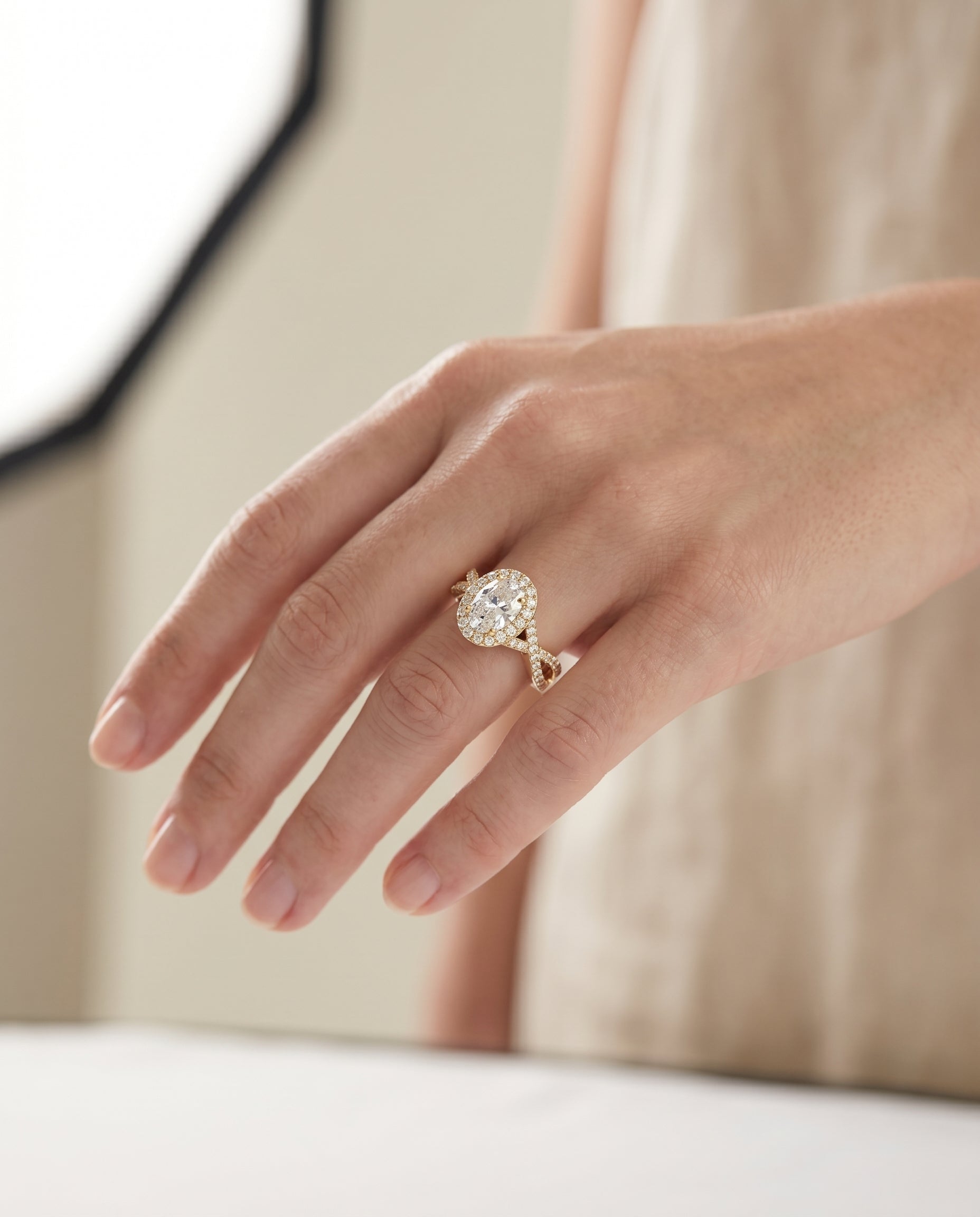 Melody Select Twisted Lattice Halo Oval Lab Diamond Engagement Ring in 18K Yellow Gold, shown on hand, angled | RockHer