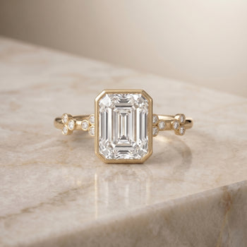 The Miley Clover Bezel Accent Solitaire Emerald Cut Engagement Ring Setting in 18K Yellow Gold