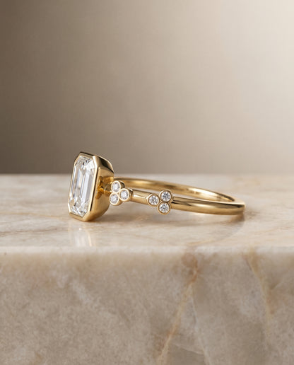 The Miley Clover Bezel Accent Solitaire Emerald Cut Engagement Ring Setting in 18K Yellow Gold