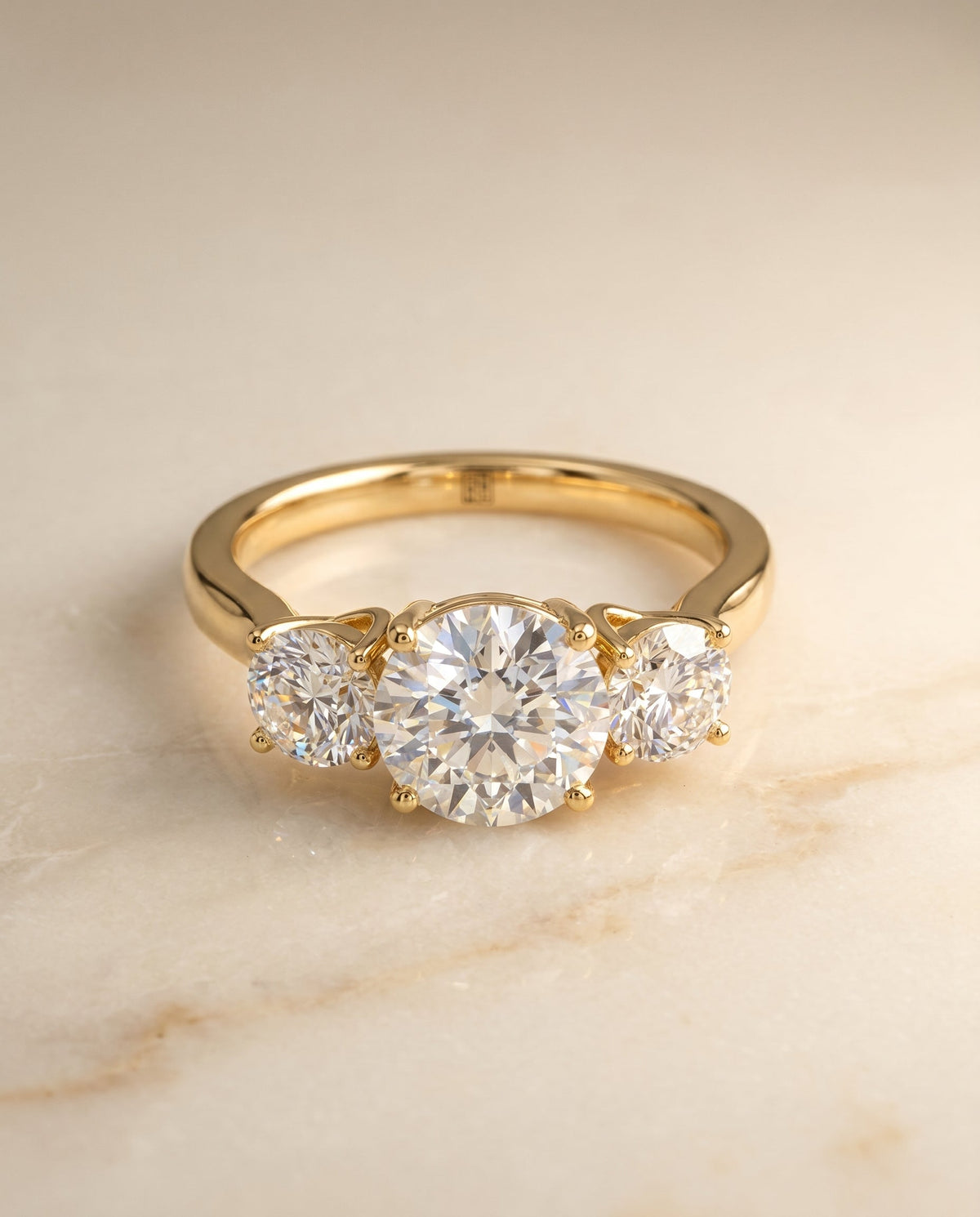 Natalie Select Three Stone Round Lab Diamond Engagement Ring in 18K Yellow Gold, shown on hand, angled | RockHer
