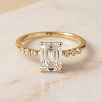 The Peggy Bezel Accent Solitaire Emerald Cut Engagement Ring Setting in 18K Yellow Gold