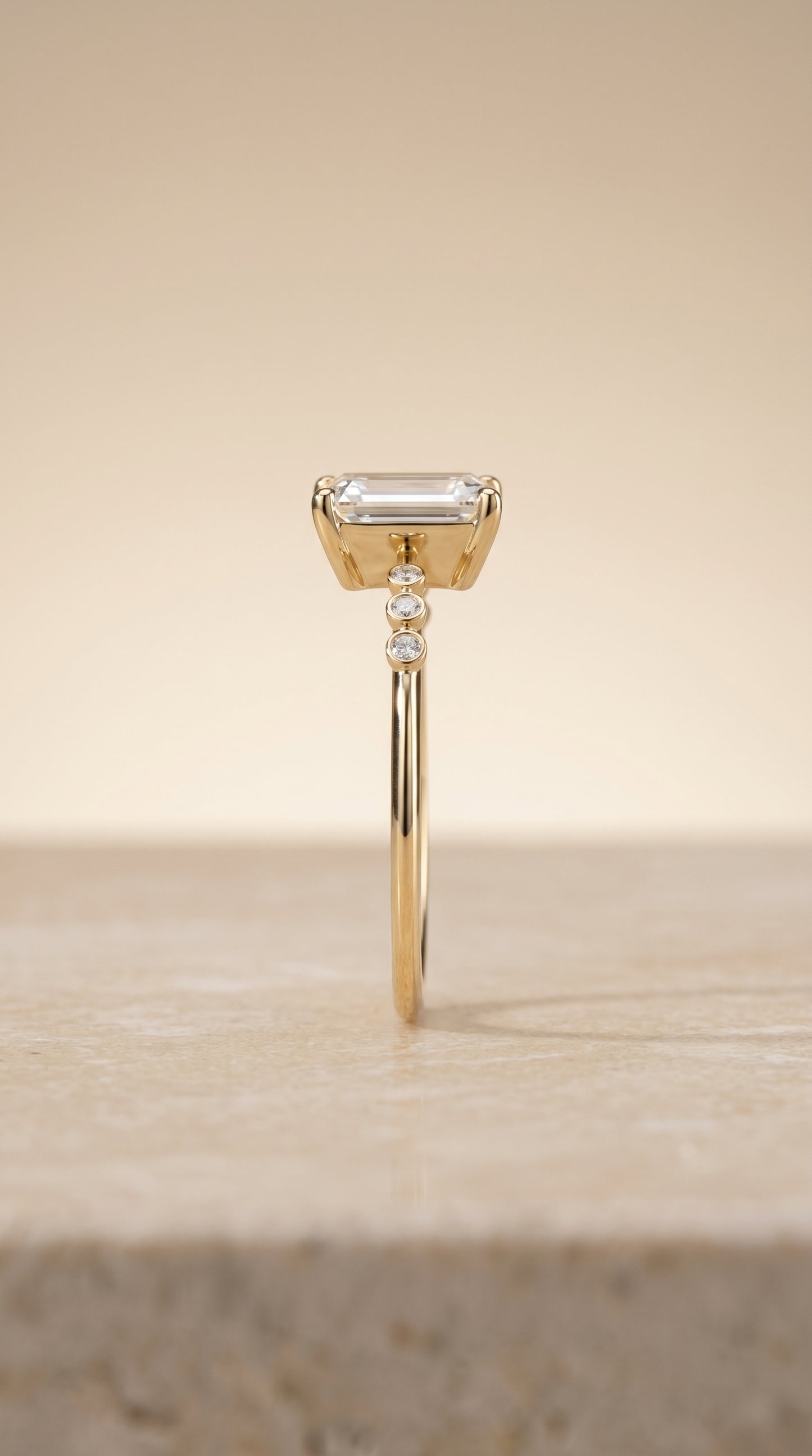 The Peggy Bezel Accent Solitaire Emerald Cut Engagement Ring Setting in 18K Yellow Gold