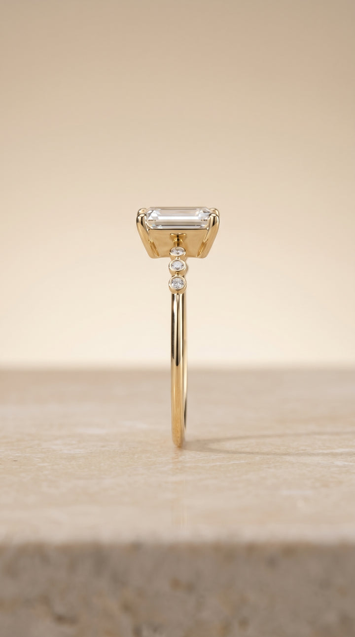 The Peggy Bezel Accent Solitaire Emerald Cut Engagement Ring Setting in 18K Yellow Gold