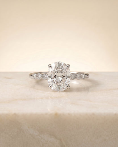 Peggy Select Bezel Accent Solitaire Oval Lab Diamond Engagement Ring in Platinum, side view | RockHer