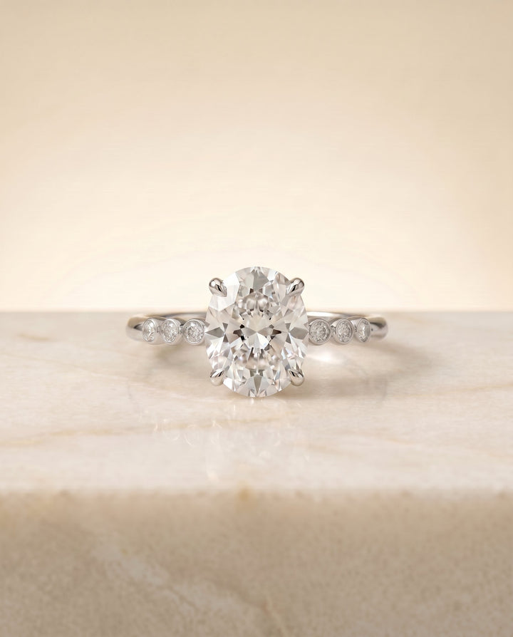 Peggy Select Bezel Accent Solitaire Oval Lab Diamond Engagement Ring in Platinum, side view | RockHer