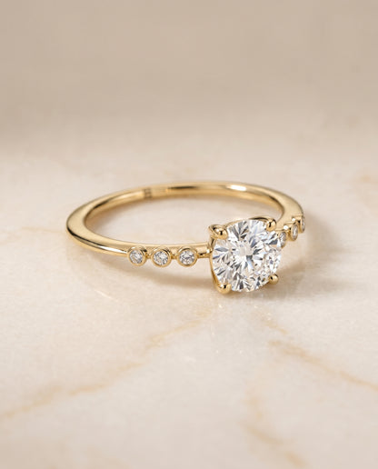 The Peggy Bezel Accent Solitaire Round Engagement Ring Setting in 18K Yellow Gold