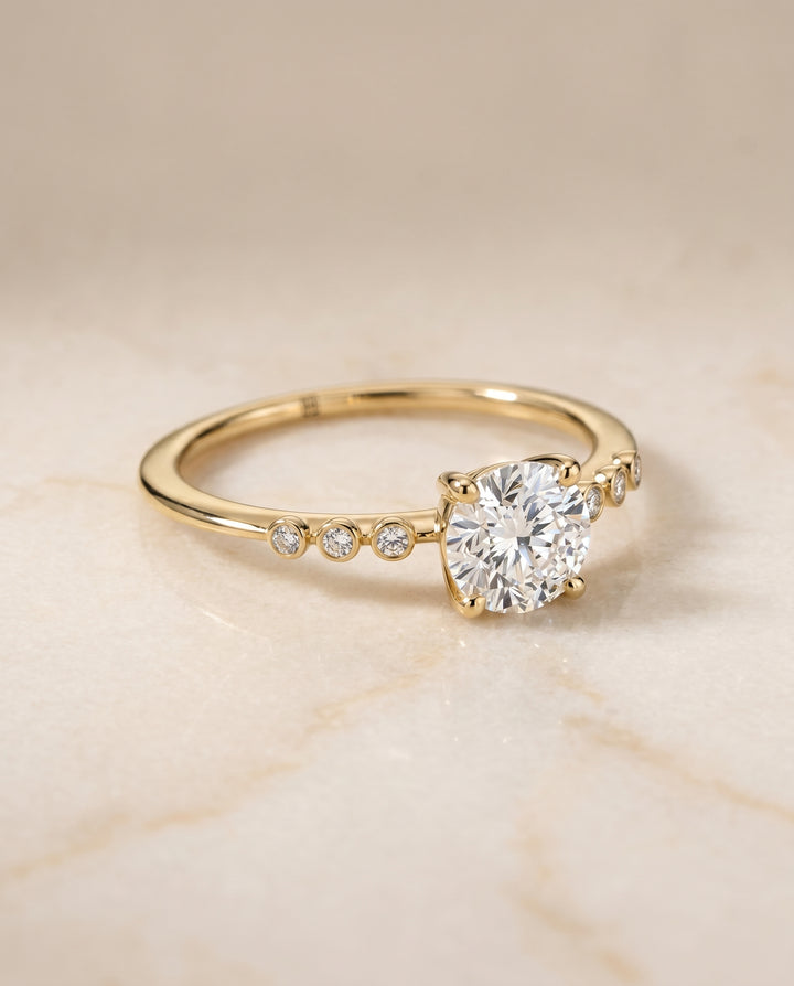 The Peggy Bezel Accent Solitaire Round Engagement Ring Setting in 18K Yellow Gold