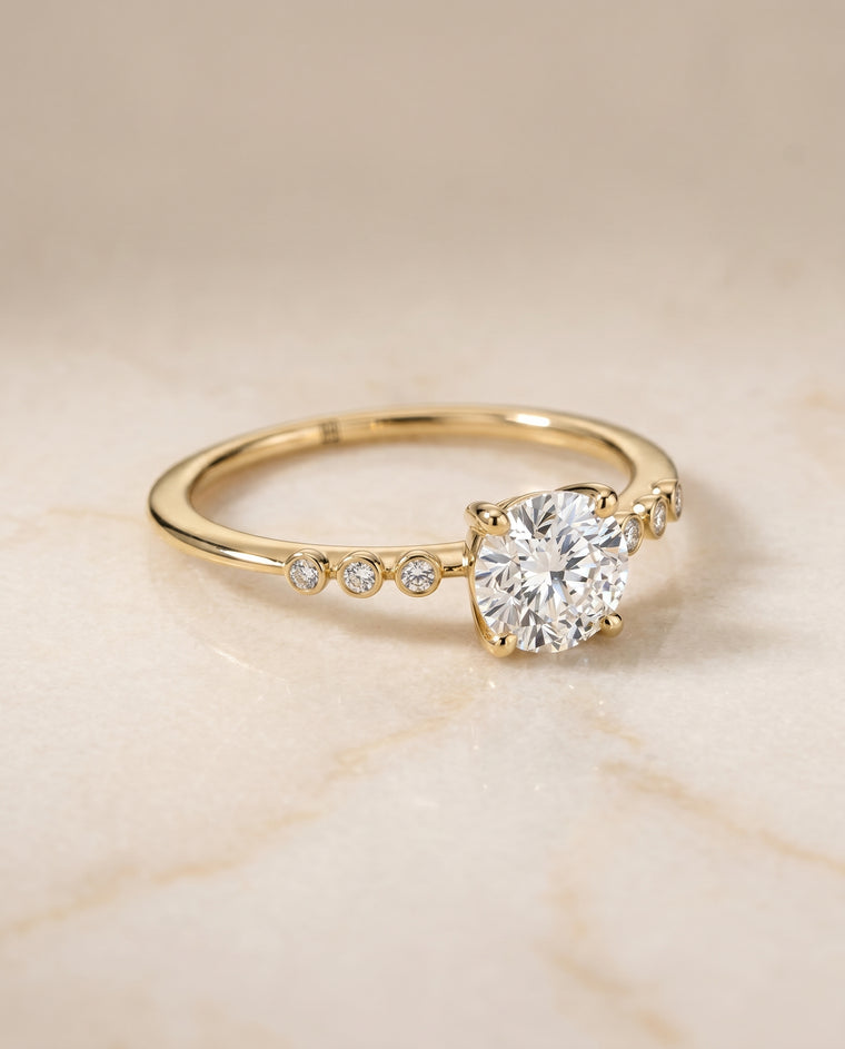 The Peggy Bezel Accent Solitaire Round Engagement Ring Setting in 18K Yellow Gold