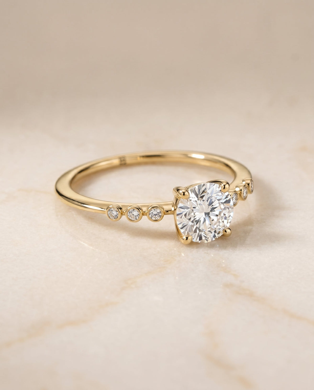 Peggy Select Bezel Accent Solitaire Round Lab Diamond Engagement Ring in 18K Yellow Gold, shown on hand, angled | RockHer