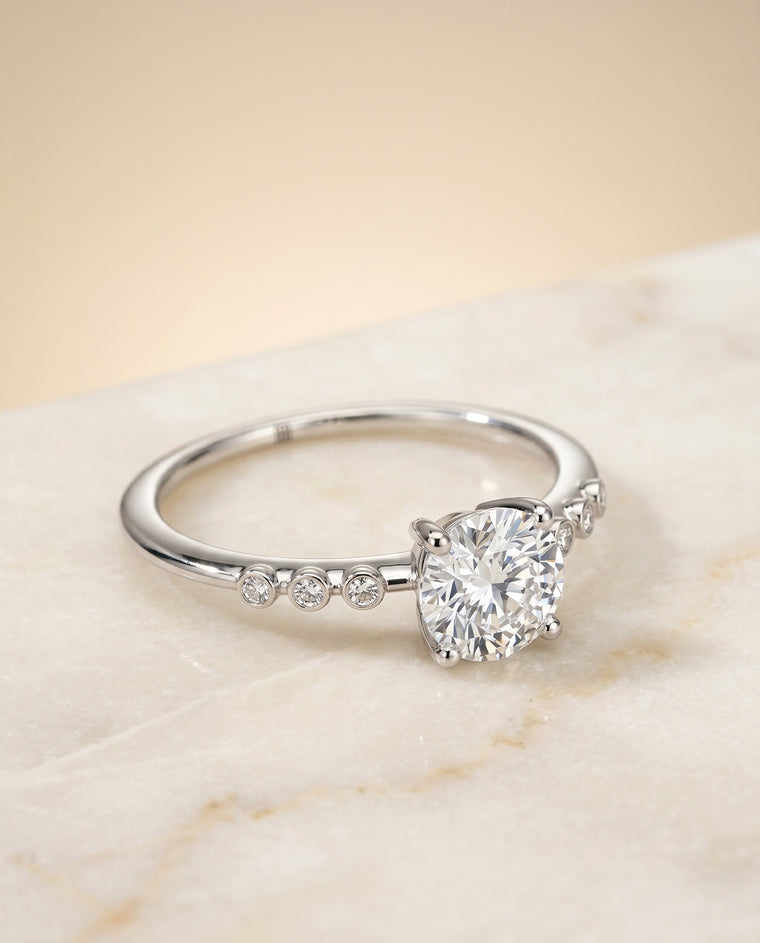 The Peggy Bezel Accent Solitaire Round Engagement Ring Setting in Platinum