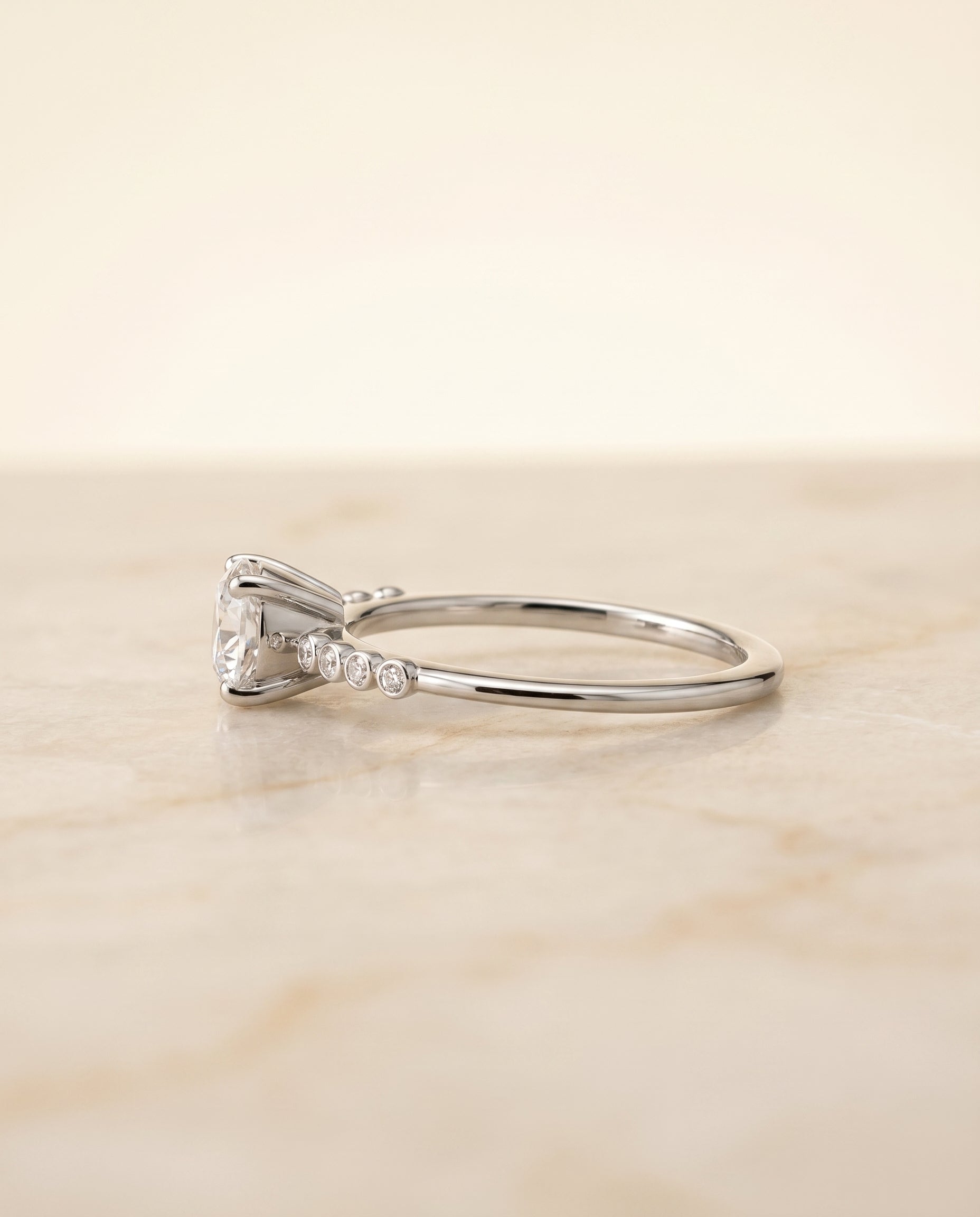 Peggy Select Bezel Accent Solitaire Round Lab Diamond Engagement Ring in Platinum, side view | RockHer