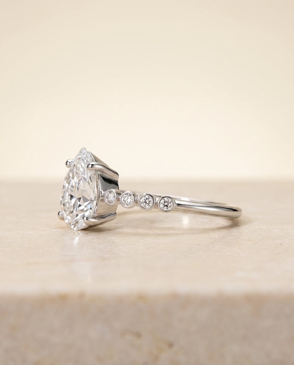 Peggy Select Bezel Accent Solitaire Princess Cut Lab Diamond Engagement Ring in Platinum, side view | RockHer
