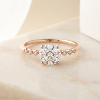 The Peggy Bezel Accent Solitaire Round Engagement Ring Setting in 14K Rose Gold