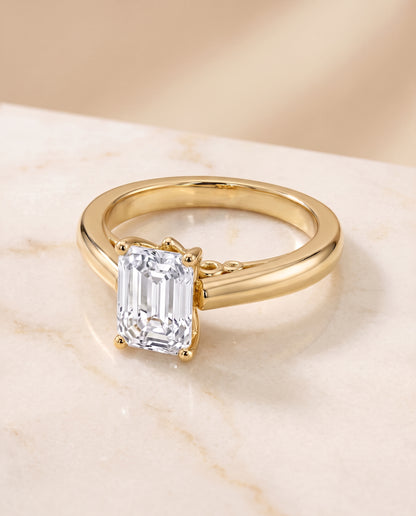 The Rio Scroll Gallery Comfort Fit Solitaire Emerald Cut Engagement Ring Setting in 18K Yellow Gold