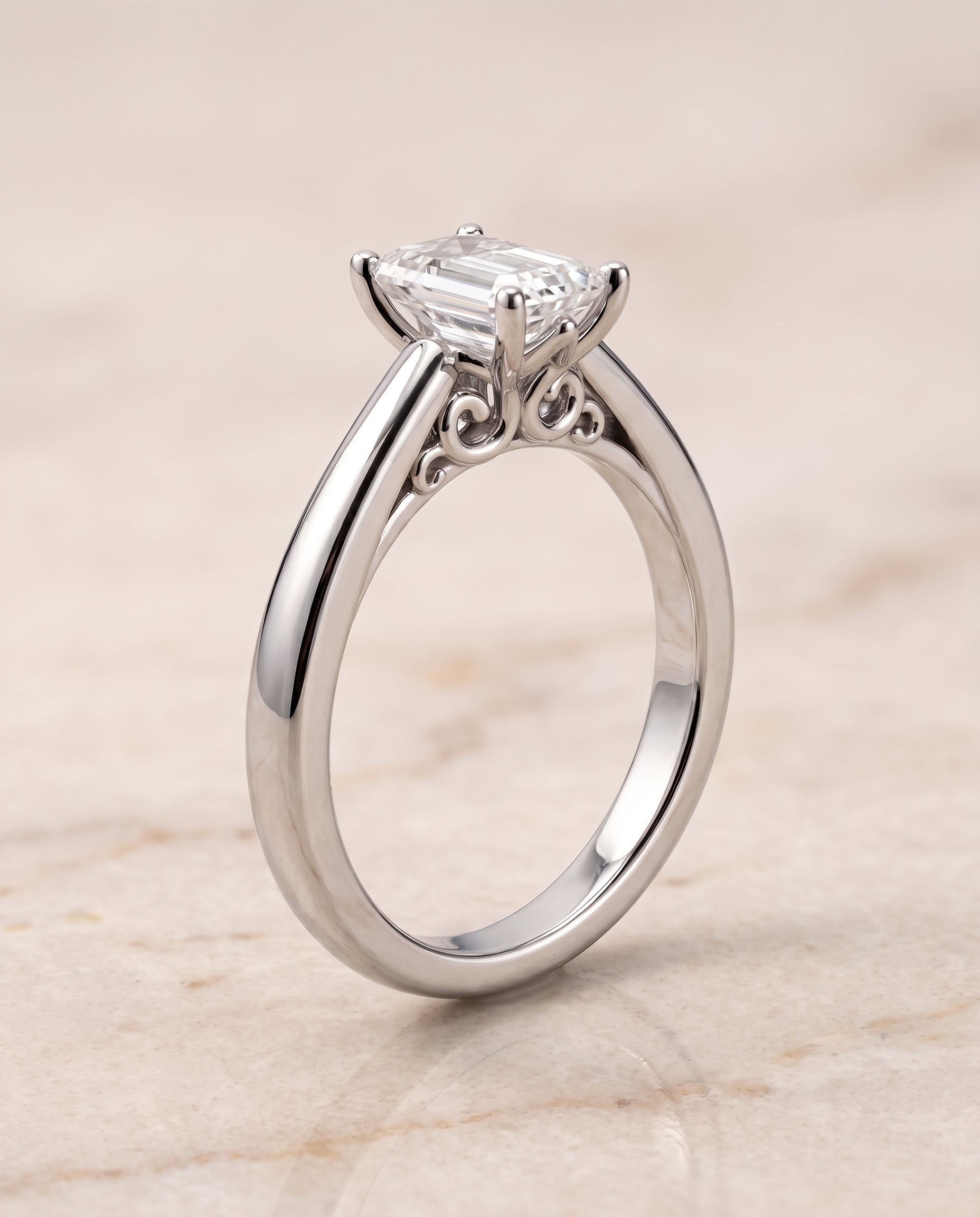 The Rio Scroll Gallery Comfort Fit Solitaire Emerald Cut Engagement Ring Setting in 18K White Gold