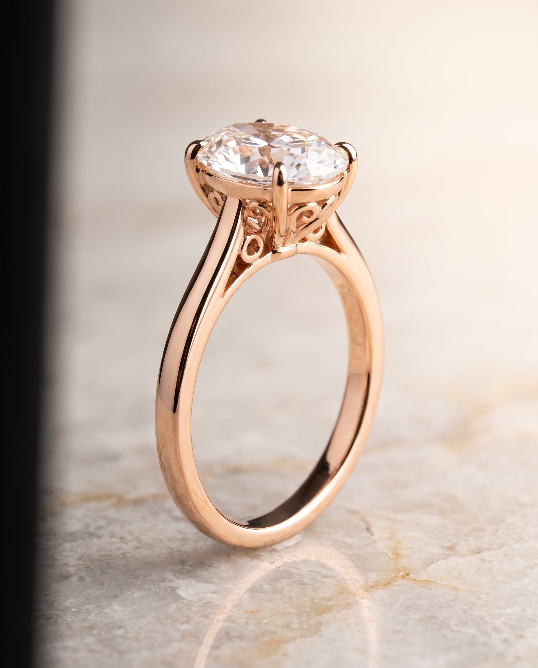 The Rio Scroll Gallery Comfort Fit Solitaire Oval Engagement Ring Setting in 14K Rose Gold
