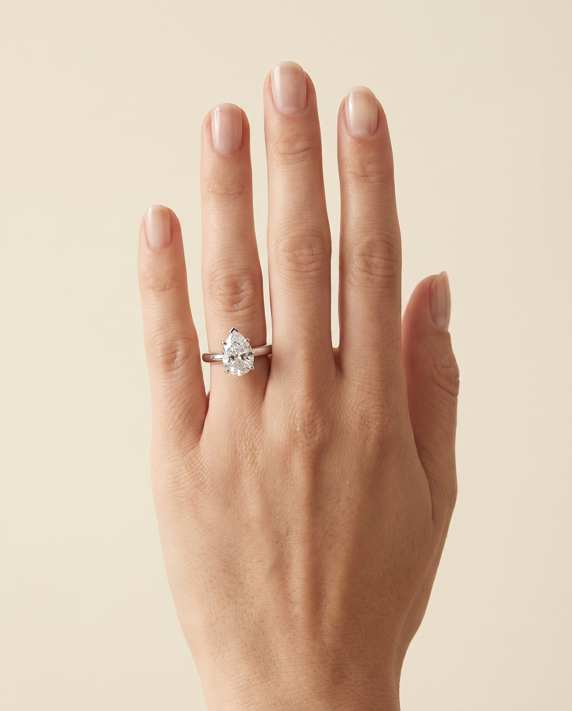 The Rio Scroll Gallery Comfort Fit Solitaire Pear Engagement Ring Setting in 18K White Gold