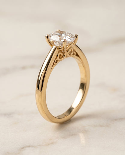 The Rio Scroll Gallery Comfort Fit Solitaire Oval Engagement Ring Setting in 18K Yellow Gold