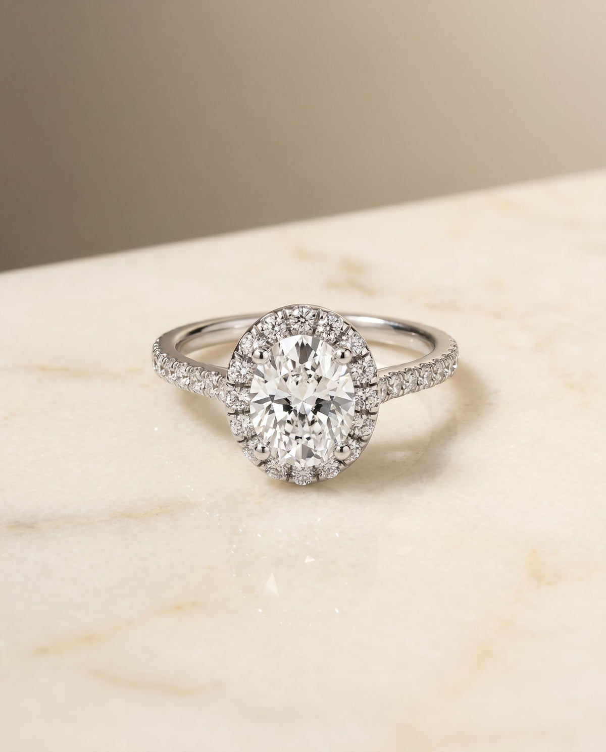 Sade Select Classic French Pavé Halo Linear Oval Lab Diamond Engagement Ring in Platinum, shown on hand, angled | RockHer