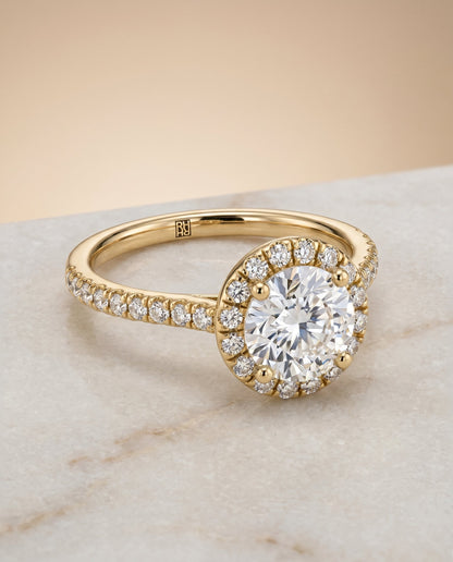 Sade Select Halo Round Lab Diamond Engagement Ring in 18K Yellow Gold, shown on hand, angled | RockHer