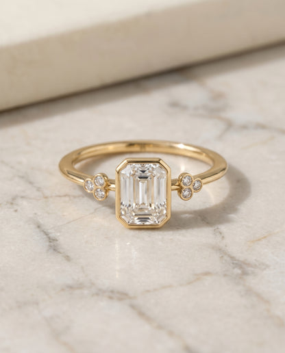 The Selena Clover Bezel Accent Solitaire Emerald Cut Engagement Ring Setting in 18K Yellow Gold