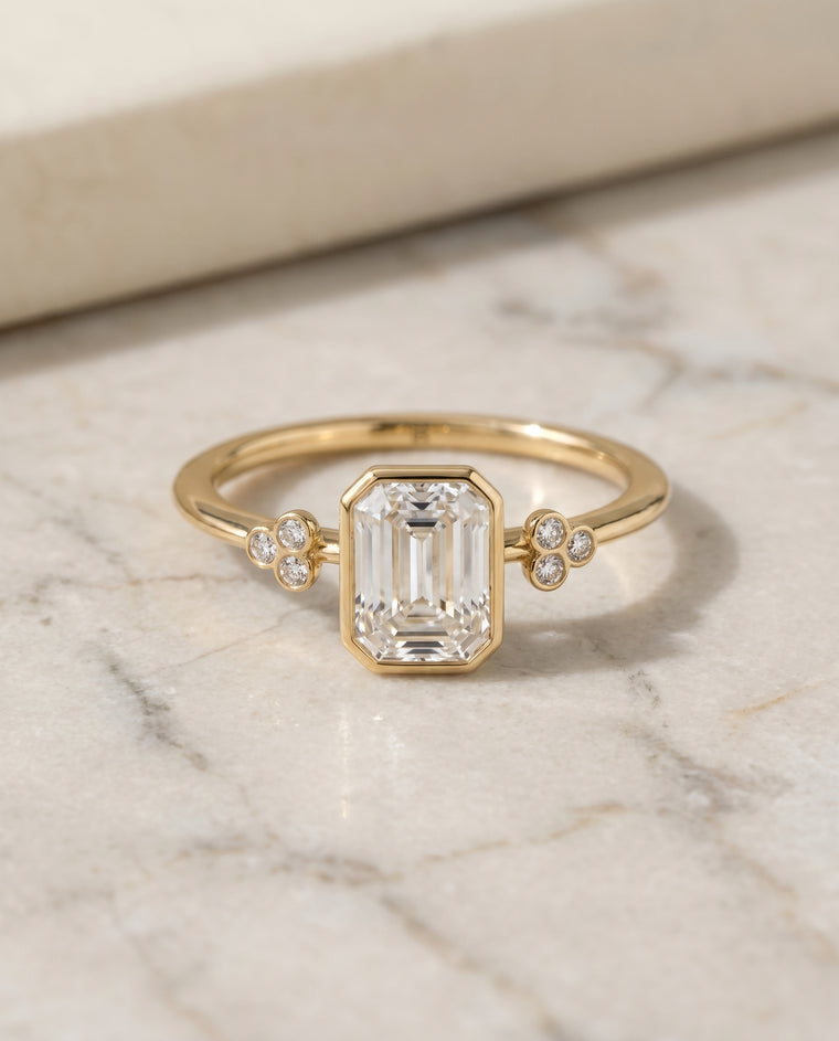 The Selena Clover Bezel Accent Solitaire Emerald Cut Engagement Ring Setting in 18K Yellow Gold