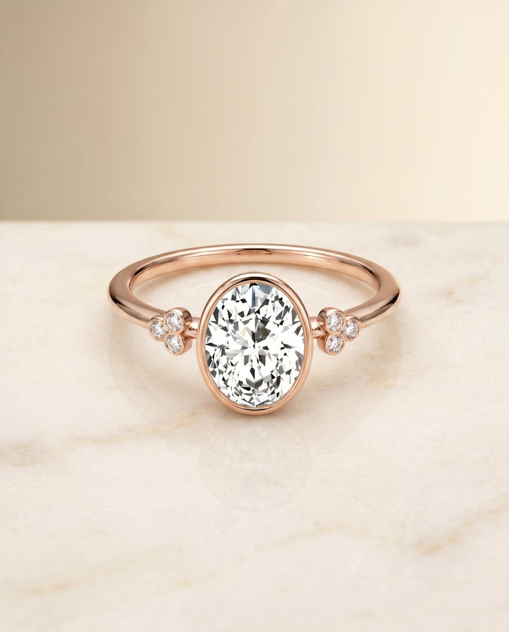 Selena Select Clover Bezel Accent Solitaire Oval Lab Diamond Engagement Ring in 14K Rose Gold, shown on hand, angled | RockHer