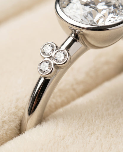 The Selena Clover Bezel Accent Solitaire Round Engagement Ring Setting in Platinum