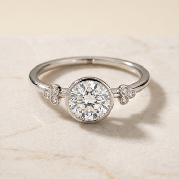 The Selena Clover Bezel Accent Solitaire Round Engagement Ring Setting in Platinum