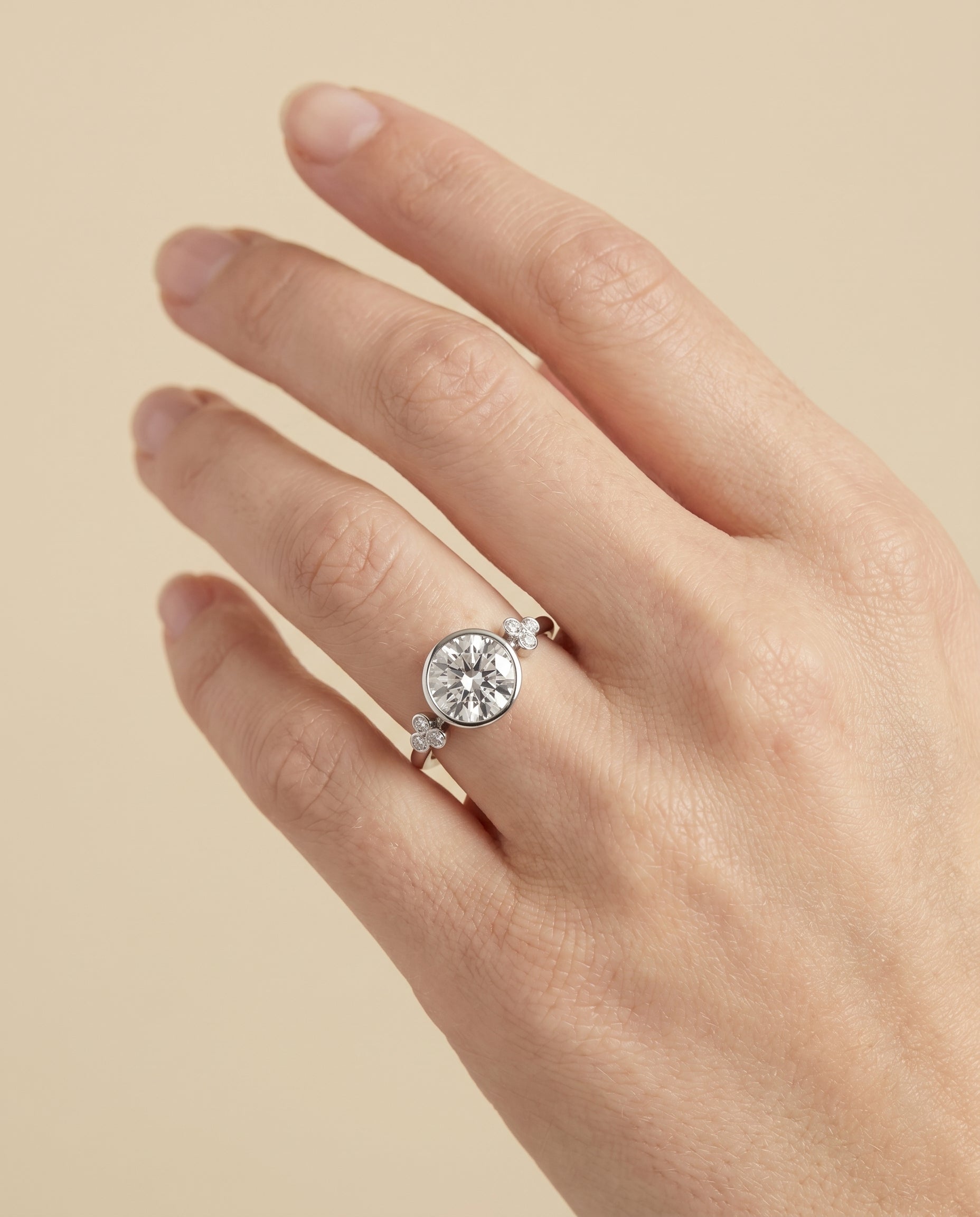 The Selena engagement ring setting in Platinum, clover bezel accent solitaire design | RockHer