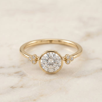 The Selena Clover Bezel Accent Solitaire Round Engagement Ring Setting in 18K Yellow Gold