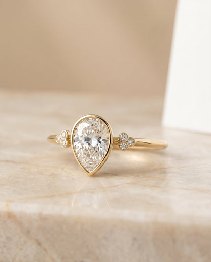 Selena Select Clover Bezel Accent Solitaire Princess Cut Lab Diamond Engagement Ring in 18K Yellow Gold, shown on hand, angled | RockHer