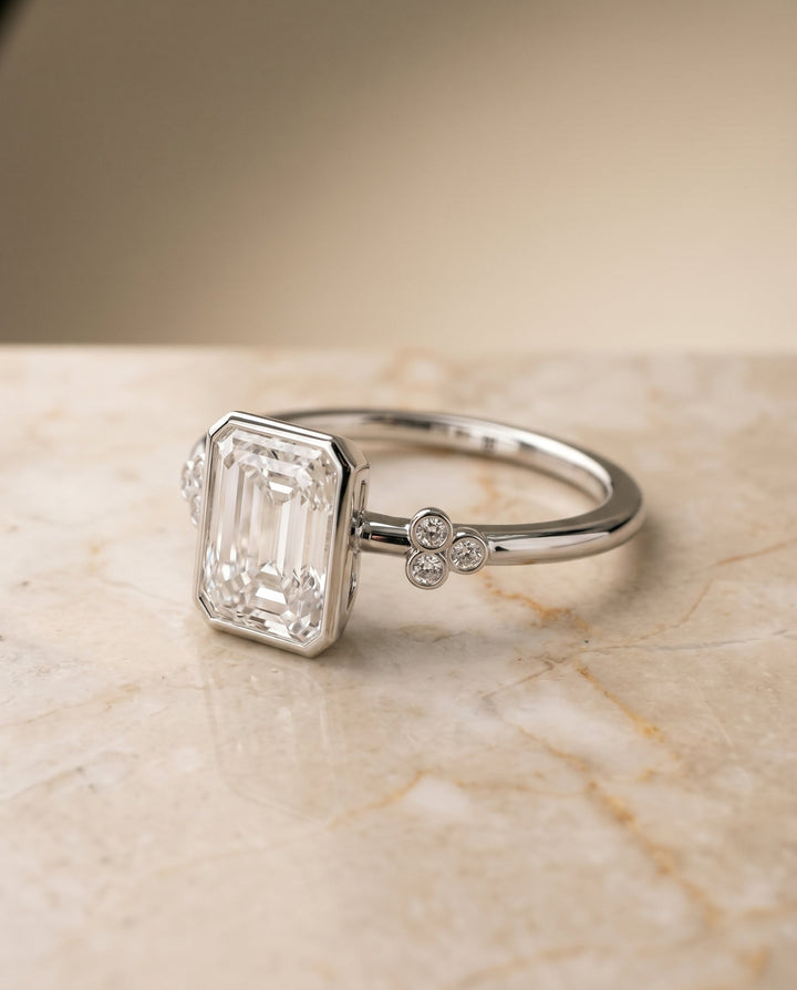 Selena Select Clover Bezel Accent Solitaire Radiant Cut Lab Diamond Engagement Ring in 18K White Gold, shown on hand, angled | RockHer