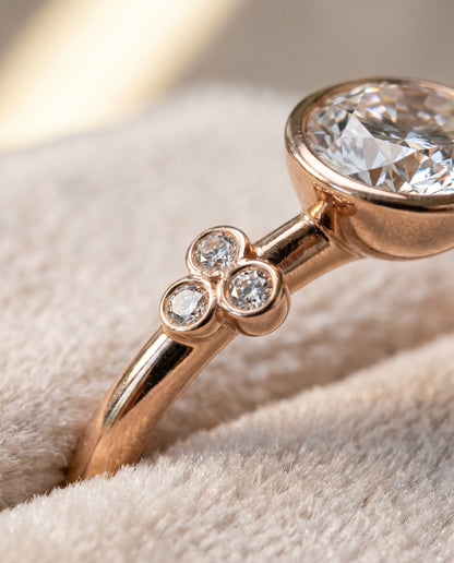 The Selena Clover Bezel Accent Solitaire Round Engagement Ring Setting in 14K Rose Gold