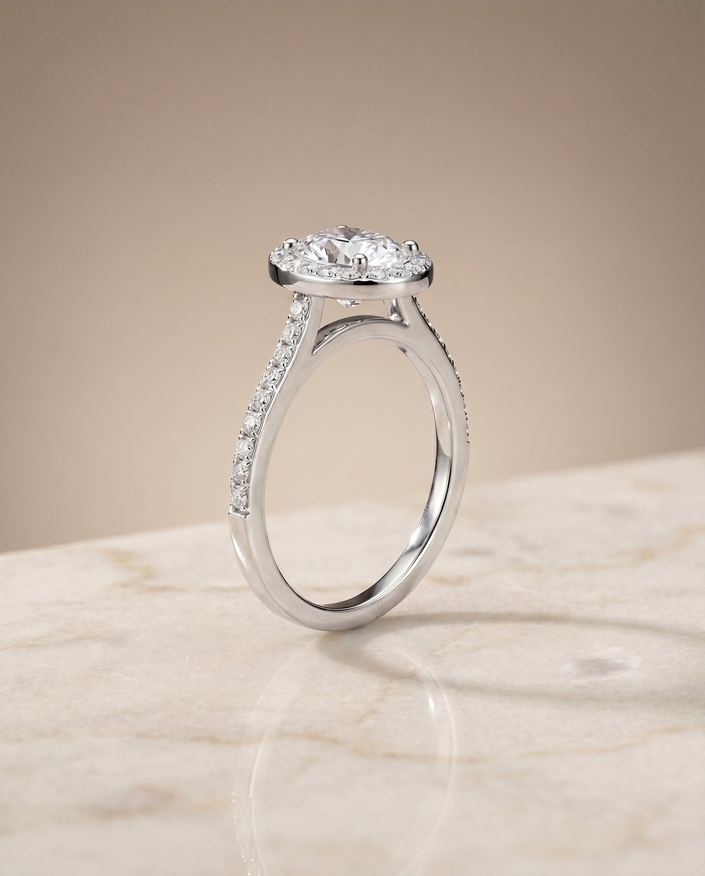 Taylor Select Pavé Halo Oval Lab Diamond Engagement Ring in 18K White Gold, shown on hand, angled | RockHer