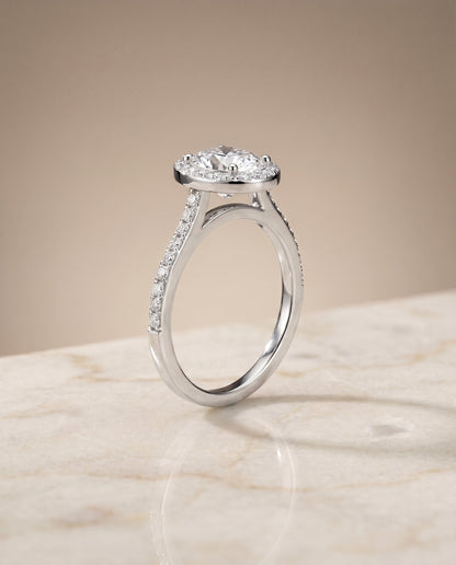 Taylor Select Pavé Halo Oval Lab Diamond Engagement Ring in 18K White Gold, shown on hand, angled | RockHer