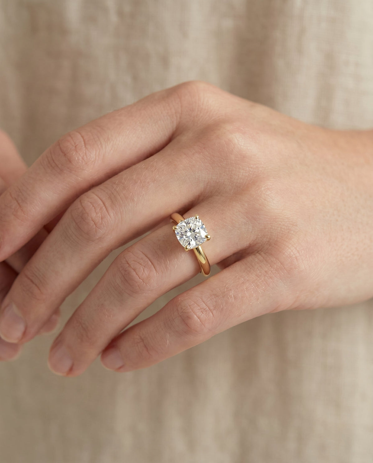 Tori Select Solitaire Cushion Cut Lab Diamond Engagement Ring in 18K Yellow Gold, shown on hand | RockHer